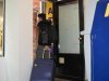 The client exits the luggage storage after collecting his suitcase